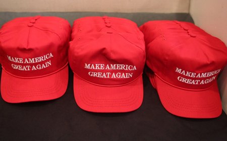 Houston Halloween display shows mannequins in red hats hanging from gallows with Mexican flag