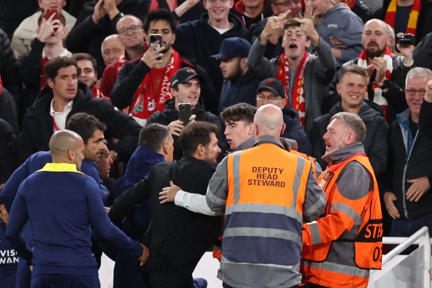 Fuming Diego Simeone held back by security as he clashes with Liverpool fans