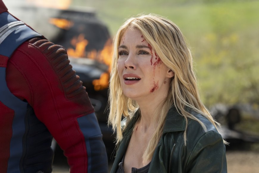 ‘Peacemaker’ Star Jennifer Holland On Harcourt’s Romantic Journey and the ‘Fun’ of Her Fight Scenes: ‘I Got to Throw “Mein Kampf” at a Nazi’s Face’