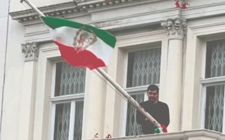 Protester scales Iranian Embassy in London, tears down regime flag, hoists pre-revolution symbol