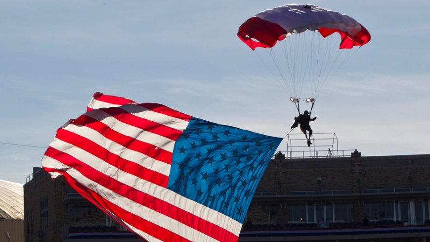 Parachutist briefly hangs above end zone during Armed Forces Bowl pregame mishap